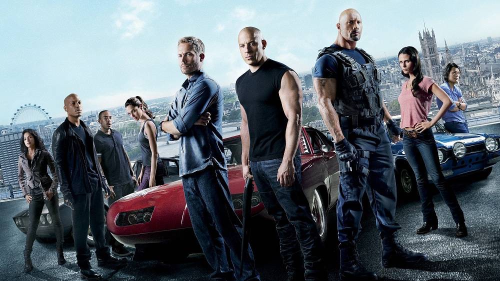 Rychle a zběsile 6 (2013). Zvláštní agent Hobbs (Dwayne Johnson) se zaměřil na novou partičku bezohledných námezdných řidičů, kteří svých schopností za volantem využívají k páchání zločinu. Skupina vedená bezohledným a chladnokrevným géniem zločinu Owenem Shawem (Luke Evans) mu ale neustále uniká, a tak se ji rozhodne zastavit jejich vlastními zbraněmi. S pomocí rychlých řidičů, kteří jako by se za volantem narodili. A těmi nejlepšími jsou přece Dom, Brian a jejich tým. Odměna za takovou práci? Úplné očištění a možnost vrátit se domů. Pro Doma je tu ještě jedna speciální motivace – jeho holka Letty (Michelle Rodriguez), kterou všichni považovali za mrtvou, žije a navíc pracuje pro nepřítele.