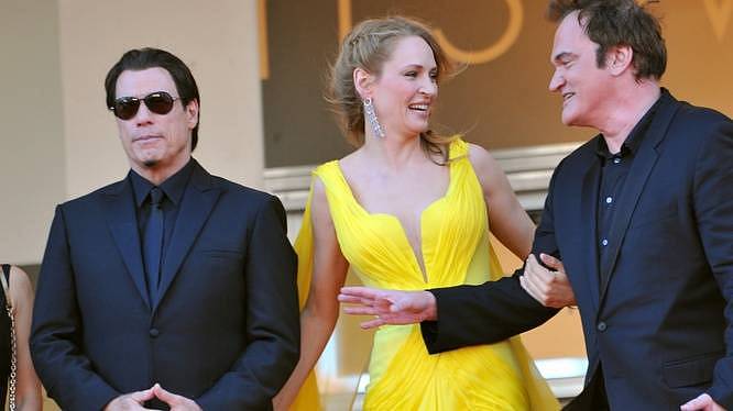 CANNES, FRANCIE - 23. KVĚTNA 2014: John Travolta, Uma Thurman a režisér Quentin Tarantino na promítání k 20. výročí jejich filmu 